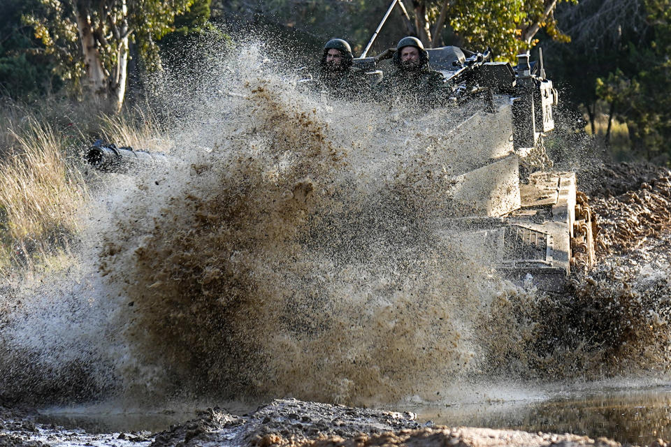 Israeli soldiers drive a tank on the border with the Gaza Strip, as seen from southern Israel, Sunday, Feb. 4, 2024. The army is battling Palestinian militants across Gaza in the war ignited by Hamas' Oct. 7 attack into Israel. (AP Photo/Ariel Schalit)