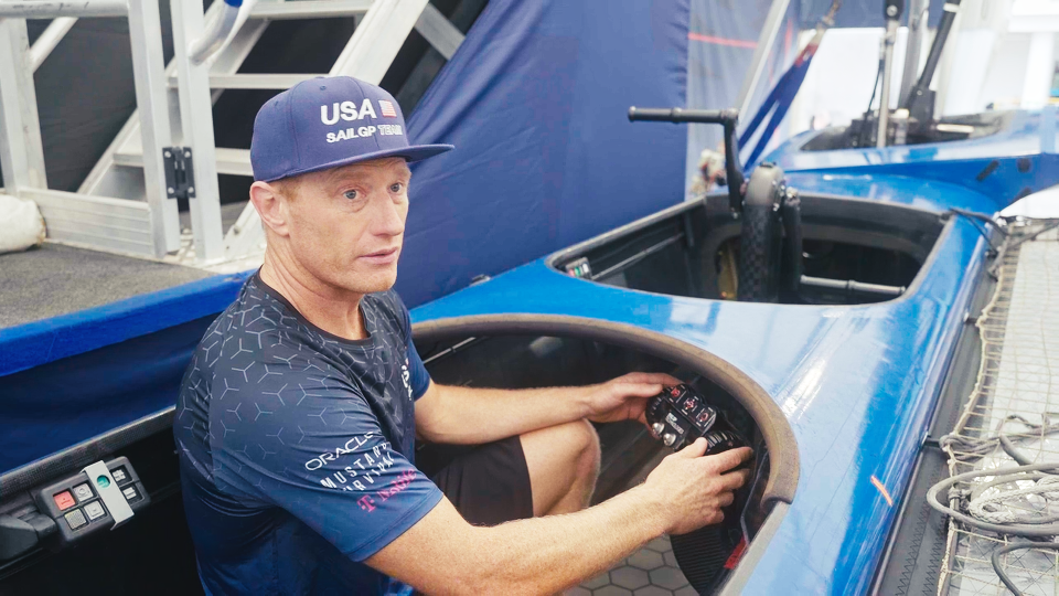 Jimmy Spithill demonstrating controls in a Team USA SailGP sail boat
