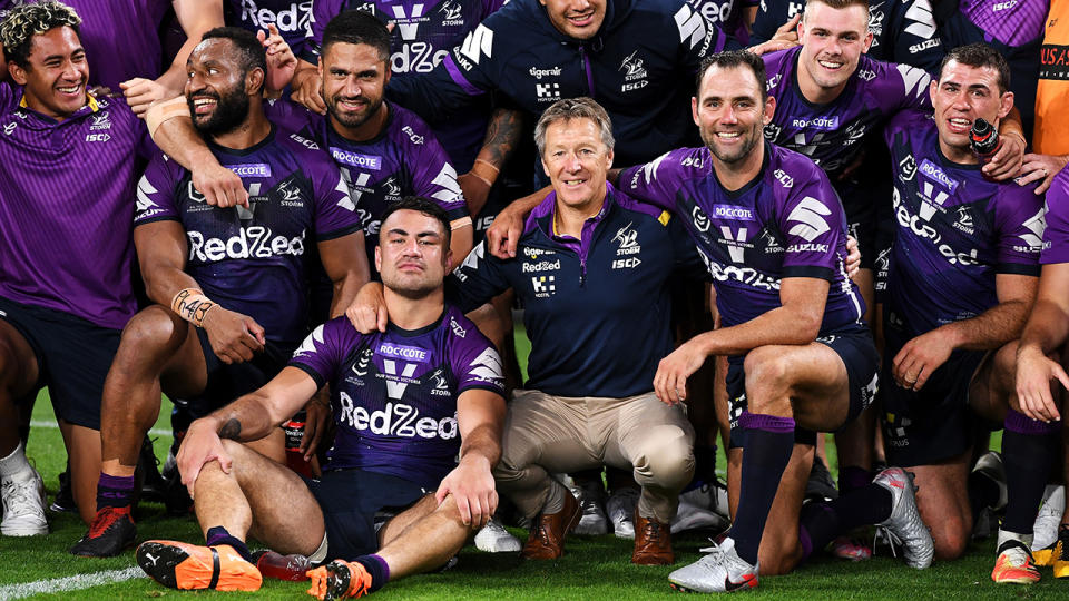 Craig Bellamy and Cameron Smith are pictured posing wth the rest of the Melbourne Storm.