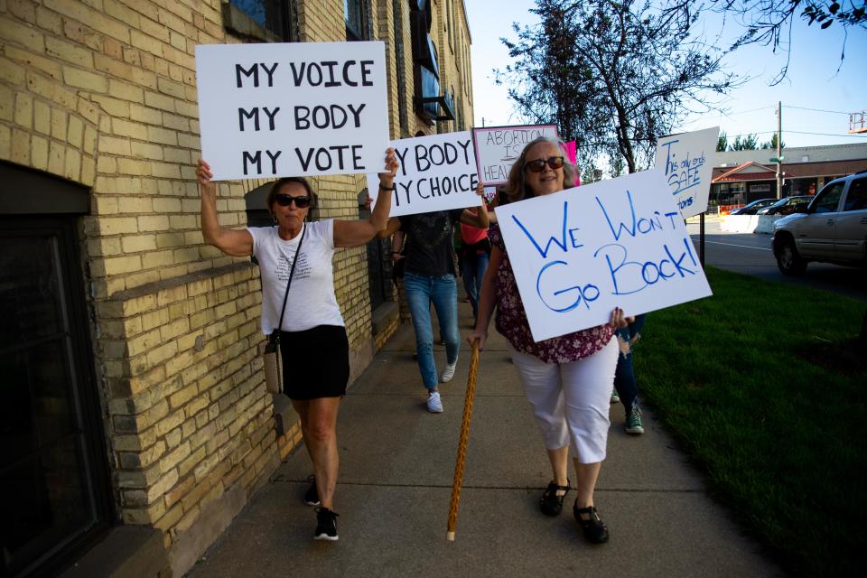 Protesters take to the streets of downtown Holland as they rally against the recent Supreme Court decision to overturn Roe v. Wade. Perrigo subsidiary HRA Pharma claims its application for over-the-counter birth control is unrelated to the recent controversy.