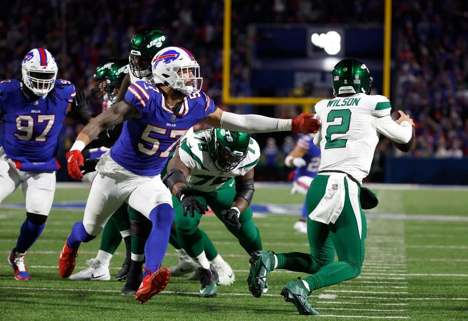 Buffalo Bills defensive end AJ Epenesa (57) forces New York Jets quarterback <a class="link " href="https://sports.yahoo.com/nfl/players/33390" data-i13n="sec:content-canvas;subsec:anchor_text;elm:context_link" data-ylk="slk:Zach Wilson;sec:content-canvas;subsec:anchor_text;elm:context_link;itc:0">Zach Wilson</a> (2) out of the pocket.