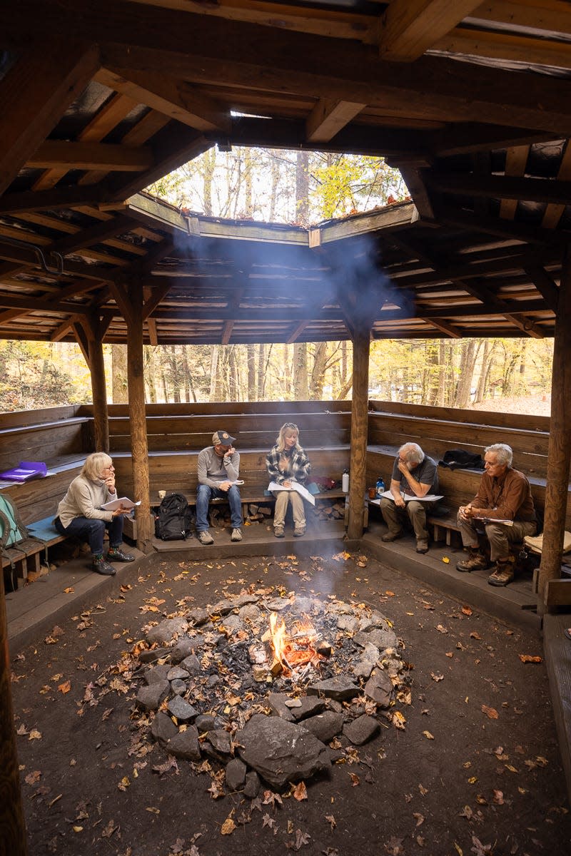 Last year’s nonfiction cohort gathers around the fire at the council house on the campus of Great Smoky Mountains Institute at Tremont during a morning workshop led by Janet McCue, author of “Back of Beyond: A Horace Kephart Biography.”
