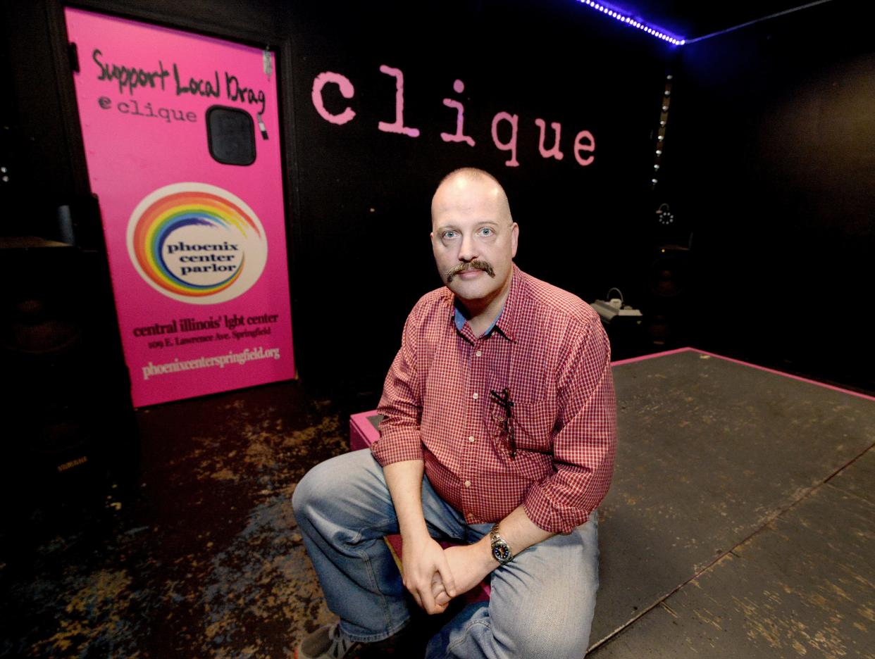 Tom Wray sits on the stage at Clique, a bar in Springfield. Wray is editor/publisher of the Illinois Eagle, a publication covering LGBTQ issues.