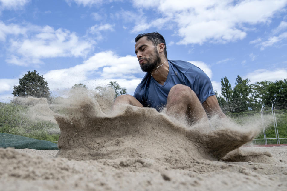 Syrian refugee Mohammad Amin Alsalami, 29, trains at the Wilmersdorf Stadium in Berlin on May 29, 2024. After leaving his war-torn hometown of Aleppo, he made it by foot to Germany through Turkey, Greece and the Balkans in October 2015. After almost a decade, he is thriving. He was granted asylum, has learned German, made new friends, and will now compete in Paris as part of the Refugee Olympic Team. (AP Photo/Ebrahim Noroozi)