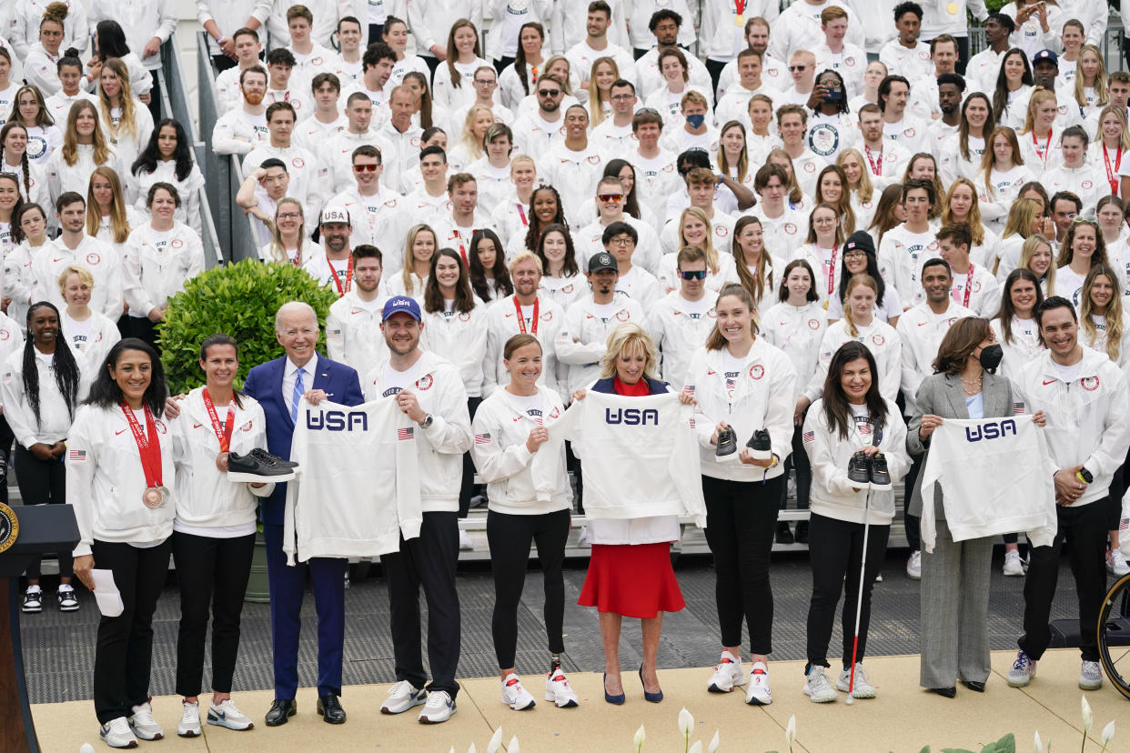 President Joe Biden, first lady Jill Biden and Vice President Kamala Harris pose for photos with Team USA jackets during an event with the Tokyo 2020 Summer Olympic and Paralympic Games, and Beijing 2022 Winter Olympic and Paralympic Games, on the South Lawn of the White House, Wednesday, May 4, 2022, in Washington. From left, Elana Meyers Taylor, Bobsled - Skeleton, 2022 Beijing Winter Games, Brittany Bowe, Speed Skating, 2022 Beijing Winter Games, Biden, John Shuster, Curling, 2022 Beijing Winter Games, Melissa Stockwell, Para Triathlon, 2020 Tokyo Summer Games, first lady Jill Biden, Kara Winger, Track & Field, 2020 Tokyo Summer Games, Danelle Umstead, Para Alpine Skiing, 2022 Beijing Winter Games, Vice President Kamala Harris and Tyler Carter, Para Alpine Skiing, 2022 Beijing Winter Games. (AP Photo/Evan Vucci)