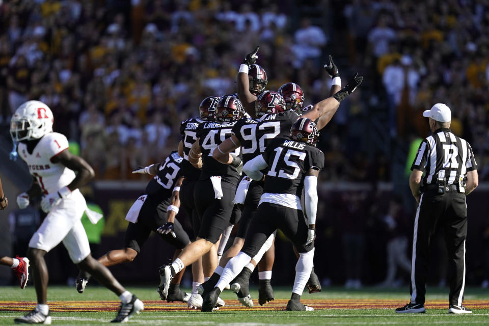 The Minnesota defense celebrate after a fumble recovery during the first half of an NCAA college football game against Rutgers, Saturday, Oct. 29, 2022, in Minneapolis. (AP Photo/Abbie Parr)