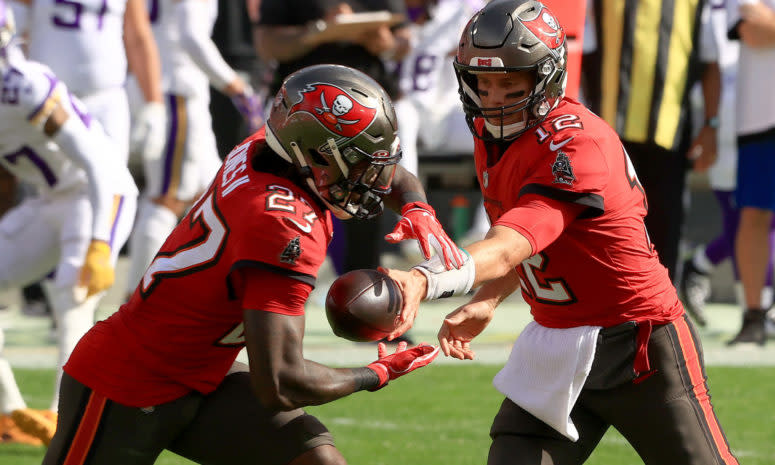 Tampa Bay Buccaneers quarterback Tom Brady hands off to Ronald Jones II during a game against the Vikings.