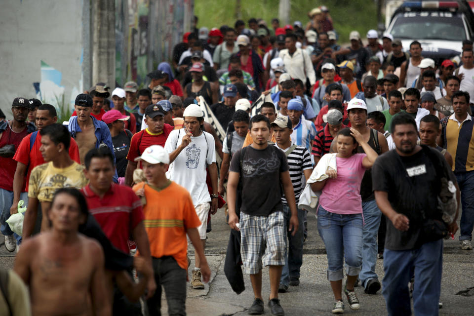 In this photo taken Tuesday, July 10, 2012, hundreds of Central American migrants make their way by foot as they leave the city of Coatzacoalcos, Mexico. Local officials estimate one thousand immigrants are stranded in this town after a rail bridge collapsed blocking the passage of cargo trains used by the travelers heading to the United States. While the number of Mexicans heading to the U.S. has dropped dramatically, a surge of Central American migrants is making the 1,000-mile northbound journey this year, fueled in large part by the rising violence brought by the spread of Mexican drug cartels. (AP Photo/Felix Marquez)