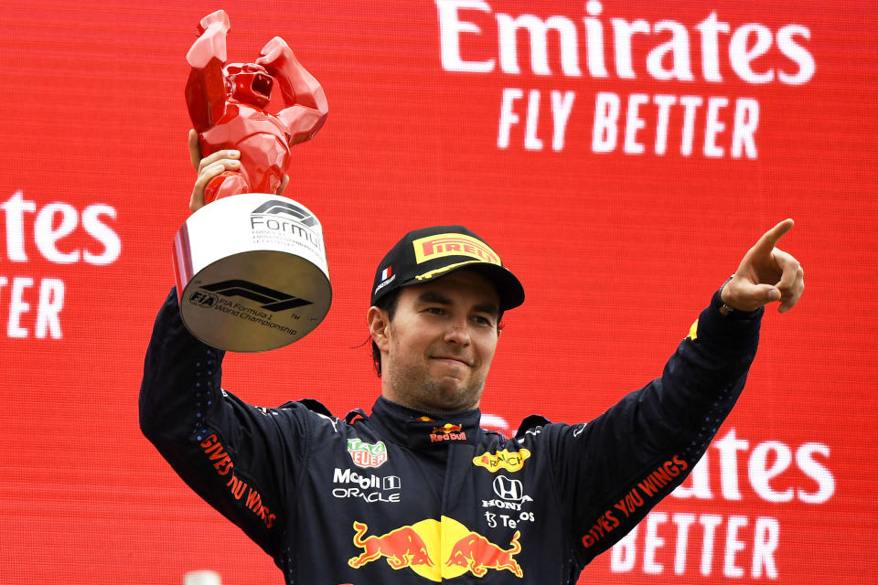 Red Bull driver Sergio Perez of Mexico celebrates from the podium his third place after the French Formula One Grand Prix at the Paul Ricard racetrack in Le Castellet, southern France, Sunday, June 20, 2021. (Nicolas Tucat/Pool via AP)