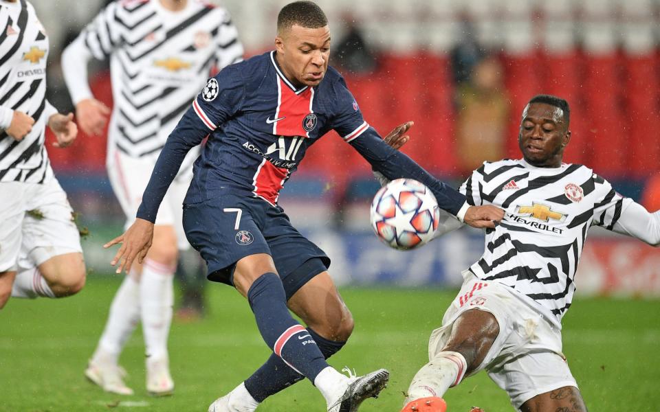 Paris Saint Germain's Kylian Mbappe (left) and Manchester United's Aaron Wan-Bissaka battle - PA