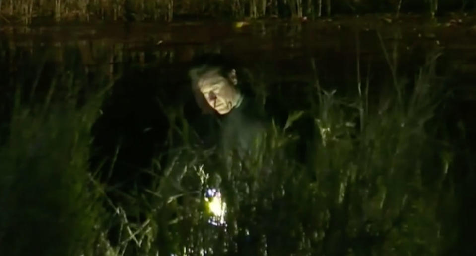 SES volunteers with torches search a rural property at Cootharaba for Elenore Lindsay who was later found dead in a dam.