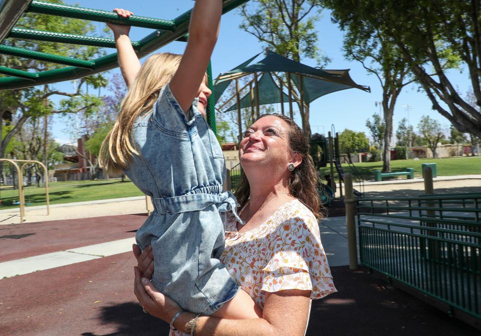Ashley Murphy plays with her daughter London Ritchey at Sunrise Park in Palm Springs, Calif., May 5, 2023.  Murphy is a breast cancer survivor.