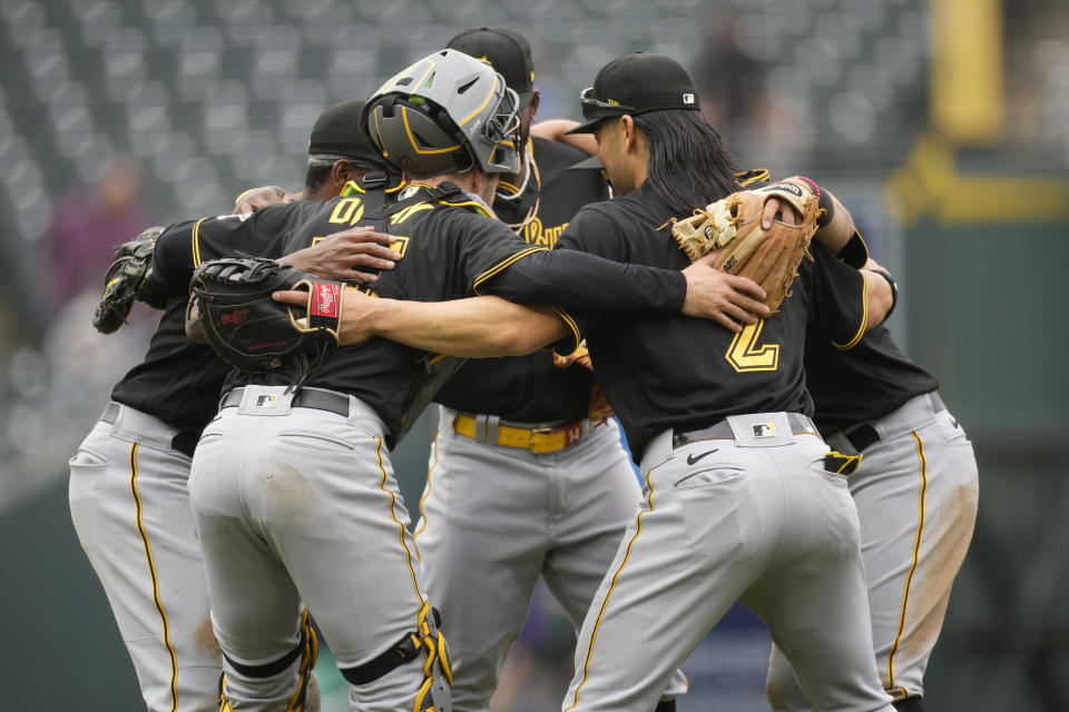 Pittsburgh Pirates celebrate after the ninth inning of a baseball game against the Colorado Rockies Wednesday, April 19, 2023, in Denver. (AP Photo/David Zalubowski)
