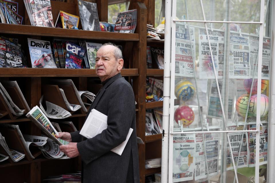 In this Tuesday, May 14, 2019, photo an elderly woman holds a sport newspaper in Karpenisi town at Evrytania region, in central Greece. As balloting for the European Parliament gets underway Thursday and continues through Sunday voters over 55 are emerging as a powerful bloc on a rapidly aging continent as younger voters stay away from the polls in growing numbers. (AP Photo/Thanassis Stavrakis)