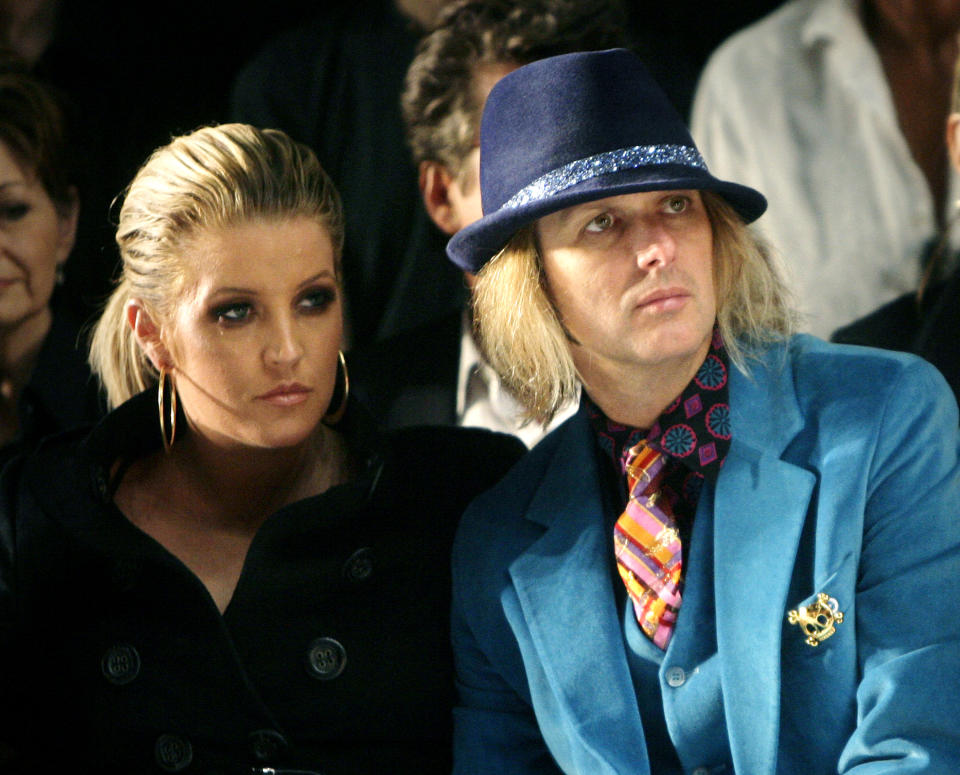 FILE - Lisa Marie Presley and her husband, Michael Lockwood, watch the Anna Sui 2008 spring/summer show at Fashion Week in New York, Sept. 10, 2007. Presley, singer and only child of Elvis, died Thursday, Jan. 12, 2023, after a hospitalization, according to her mother, Priscilla Presley. She was 54. (AP Photo/Seth Wenig, File)