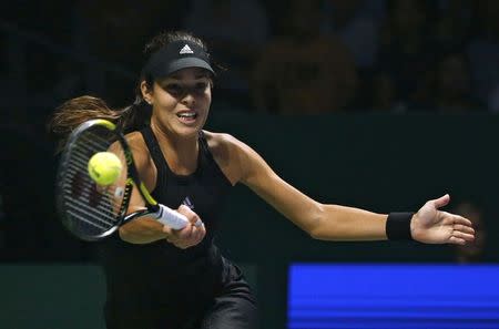 Ana Ivanovic of Serbia plays a shot against Serena Williams of the U.S. during their WTA Finals singles tennis match in Singapore October 20, 2014. REUTERS/Edgar Su