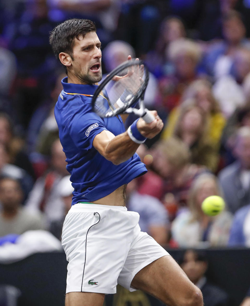 Team Europe's Novak Djokovic hits a return to Team World's Kevin Anderson at the Laver Cup tennis event, Saturday, Sept. 22, 2018, in Chicago. (AP Photo/Kamil Krzaczynski)