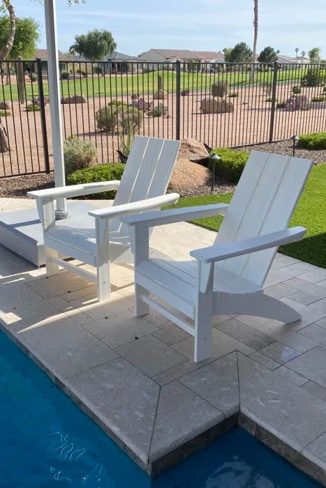 Reviewer's photo of the Adirondack chairs in the color White at the side of a pool