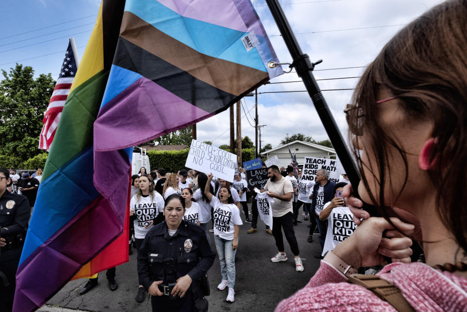 Protesters shout out slogans and carry signs as police officers separate them from counter-protesters at the Saticoy Elementary School in the North Hollywood section of Los Angeles, Friday, June 2, 2023. Los Angeles elementary school has become a flashpoint for Pride Month events and activities across California. (AP Photo/Richard Vogel)