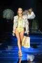 <p>On the closing day of MFW SS22 the model walked the <a href="https://www.elle.com/uk/fashion/a37749343/versace-and-fendi-joint-show/" rel="nofollow noopener" target="_blank" data-ylk="slk:Fendace;elm:context_link;itc:0;sec:content-canvas" class="link ">Fendace</a> show wearing a yellow, gold and white printed swimsuit, boxy jacket, gold earrings, necklace and carrying a coordinated tote bag. </p>