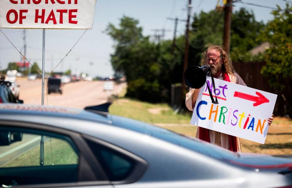 No Hate in Texas protesters shout as churchgoers leave after service at Stedfast Baptist Church on June 26, 2022, in Watauga.