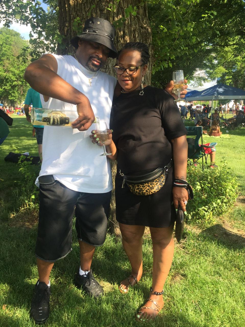 Tim Graves pours wine for his mother, Marcelene Robinson Sterling, at the 2021 Vintage Indiana Wine Fest at Military Park.