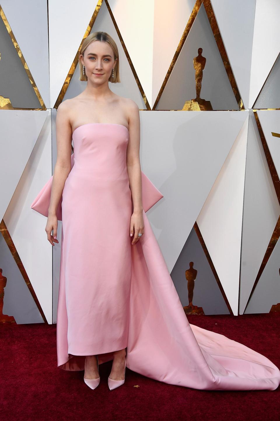 <p>Saoirse Ronan turned heads wearing a very feminine soft pink strapless number with bow detail. This look was a stylist favourite and designed by Calvin Klein by Appointment.</p>