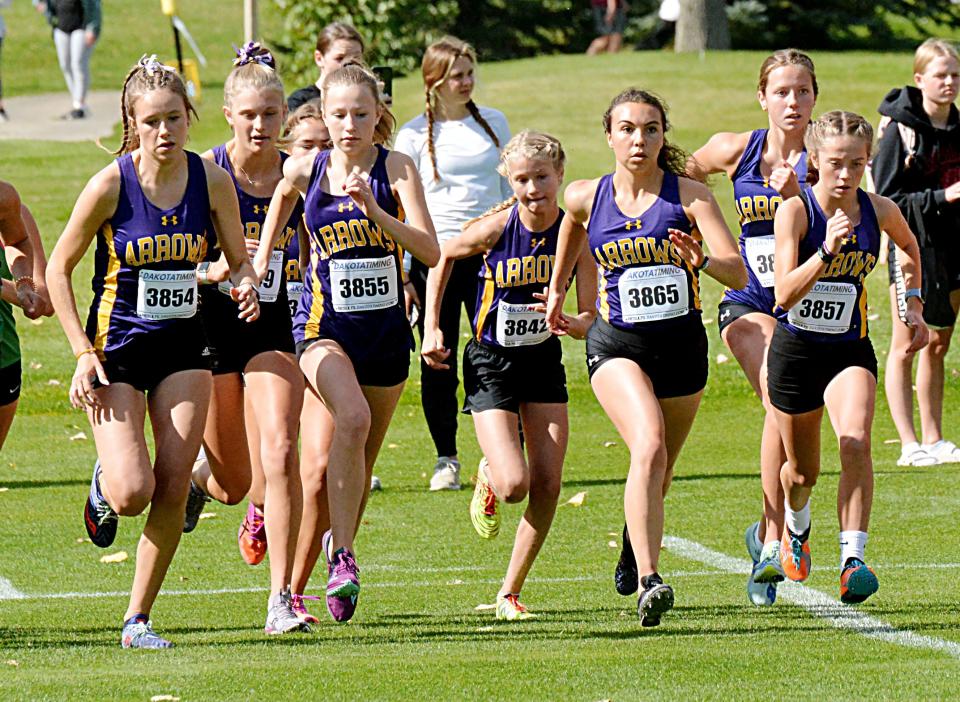 Watertown runners, from left, Emma List, Isabella Horning, Grace List, Olivia Anderson, Victoria Smith, Ava Jensen and Kate McElroy open the varsity girls' 5,000-meter race Thursday, Sept. 29, 2022 during the Watoma Invitational cross country meet at Cattail Crossing Golf Course. Hidden behind Horning is Elizabeth Rieffenberger.