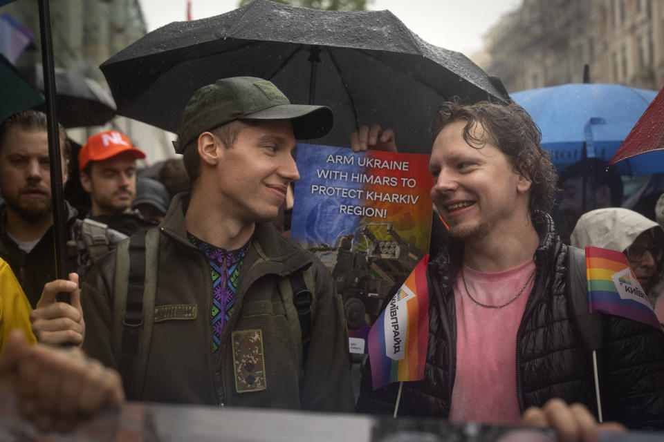 A Ukrainian officer and LGBT activist attend the pride march in Kyiv, Ukraine, Sunday, June 16, 2024. Several hundred LGBT Ukrainian servicemen and other protesters joined a pride march in central Kyiv Sunday seeking legal reforms to allow people in same-sex partnerships to take medical decisions for wounded soldiers and bury victims of the war with Russia that extended across Ukraine more than two years ago. (AP Photo/Efrem Lukatsky)