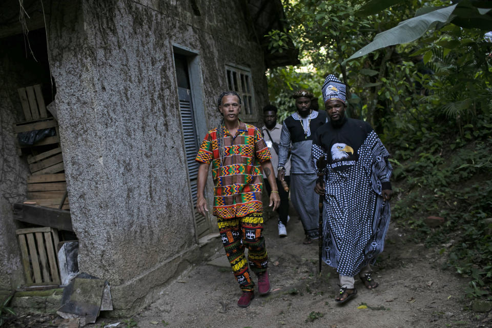 King Tchongolola Tchongonga Ekuikui VI, of Angola's Bailundo kingdom, right, visits the "Quilombo do Camorim," a community of descendants of runaway slaves, many from Angola, in Rio de Janeiro, Brazil, Wednesday, Nov. 8, 2023. (AP Photo/Bruna Prado)