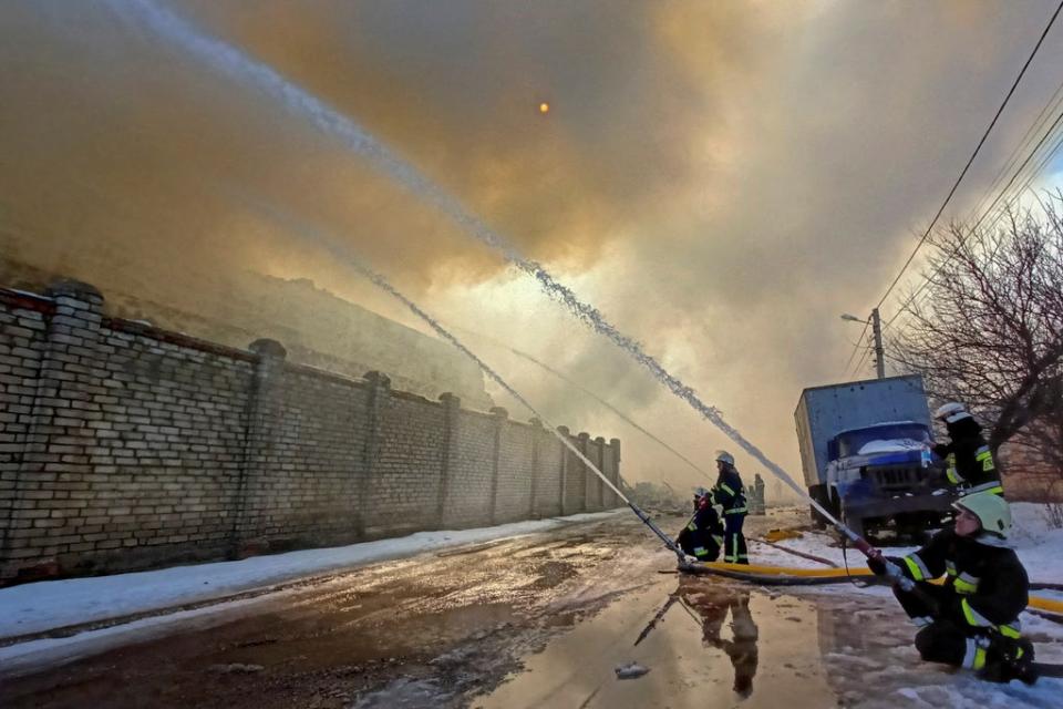 Rescuers work at a site of a warehouse storing products burned after shelling in Kharkiv (REUTERS)