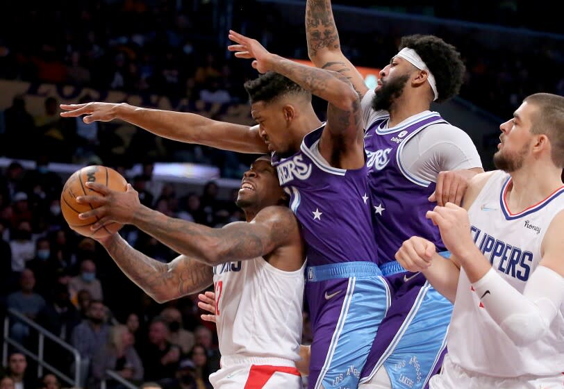 LOS ANGELES, CALIF. - DEC. 3, 2021. Lakers guard Eric Bledsoe gets fouled by Lakers guard .