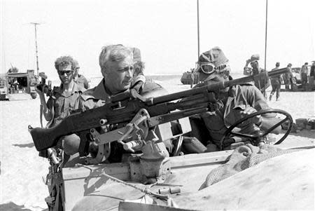 Israeli Major General in the Reserves Ariel Sharon (front L) rides in a jeep in this October 1973 file photo released by Israel's Defence Ministry. REUTERS/Israel's Defence Ministry/Handout/Files