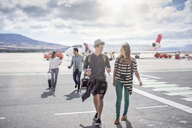 Passengers getting out of the airplane on a sunny day