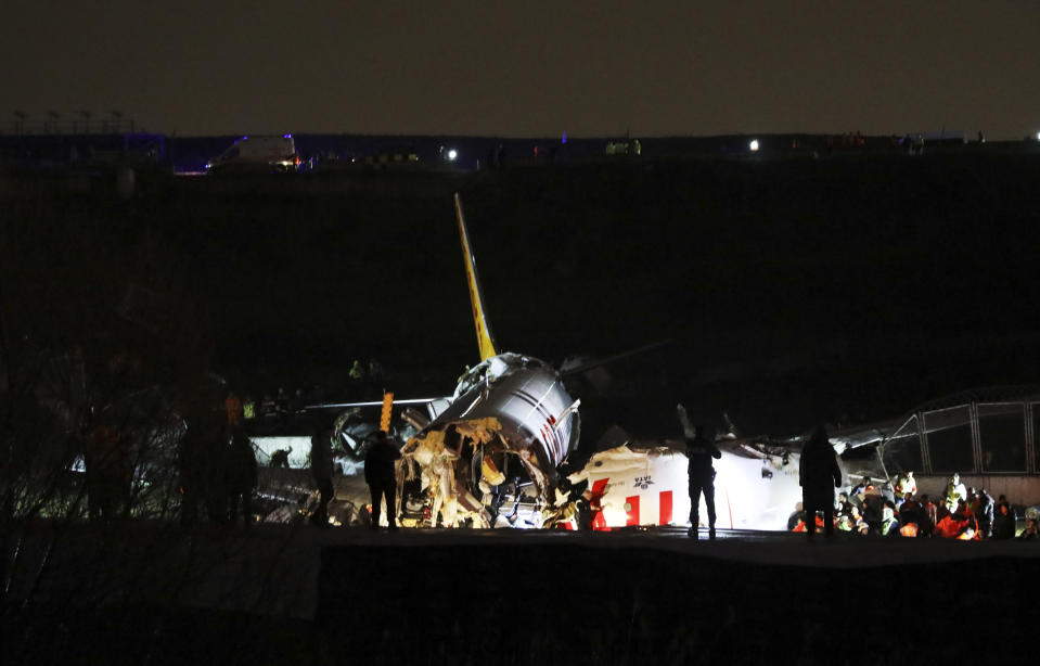 Emergency personnel work around the wreckage of an airplane in Sabiha Gokcen Airport, in Istanbul, Wednesday, Feb. 5, 2020. A plane skidded off the runway Wednesday at Istanbul’s Sabiha Gokcen Airport, crashing into a field and breaking into pieces. Passengers were seen evacuating through cracks in the plane and authorities said at least 21 people were injured. (AP Photo)