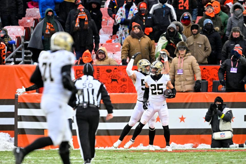 Teammates congratulate New Orleans Saints safety Daniel Sorensen (25) after he intercepted a pass intended for Cleveland Browns wide receiver David Bell during the second half of an NFL football game, Saturday, Dec. 24, 2022, in Cleveland. (AP Photo/David Richard)