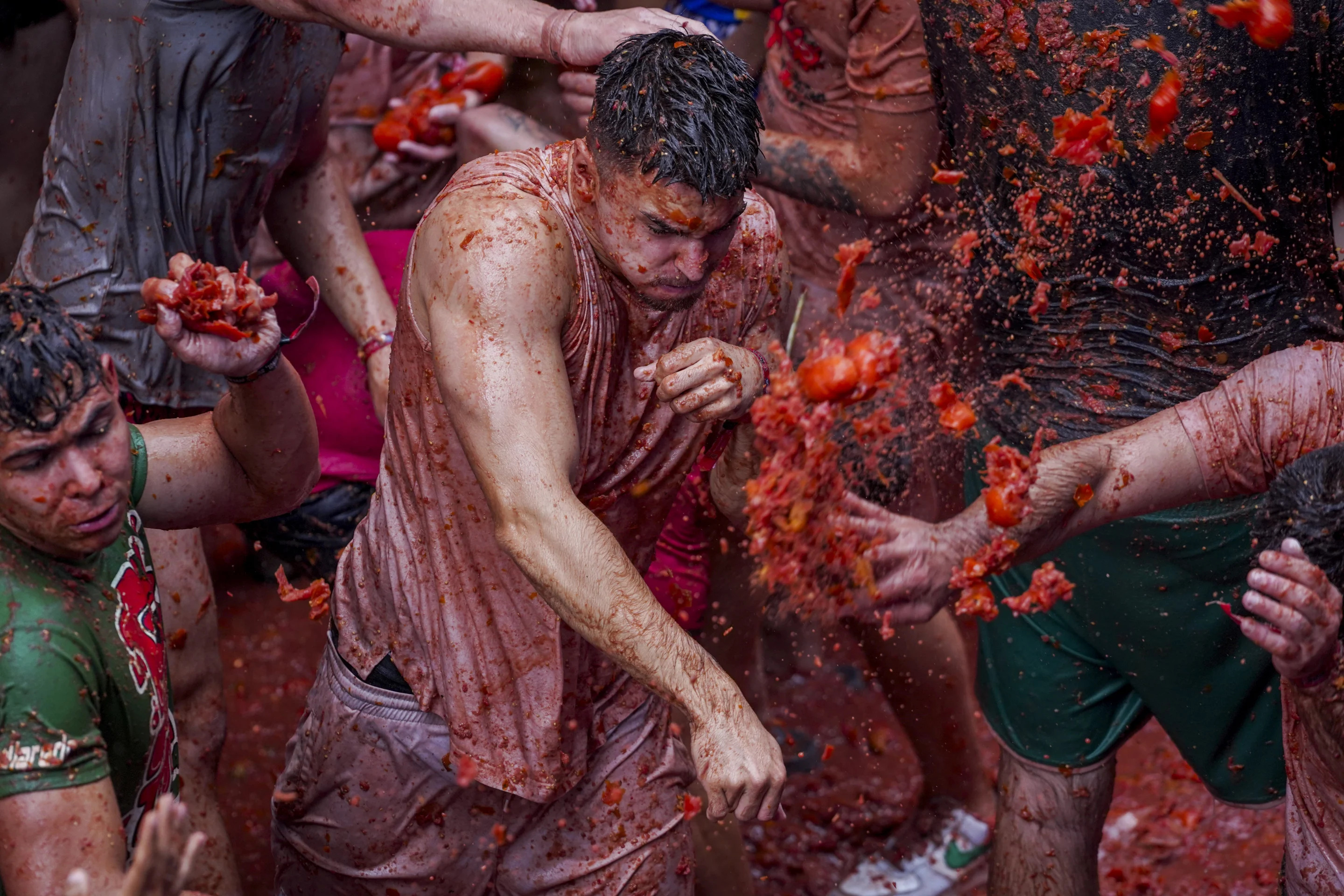 Revellers throw tomatoes at each other during the annual 