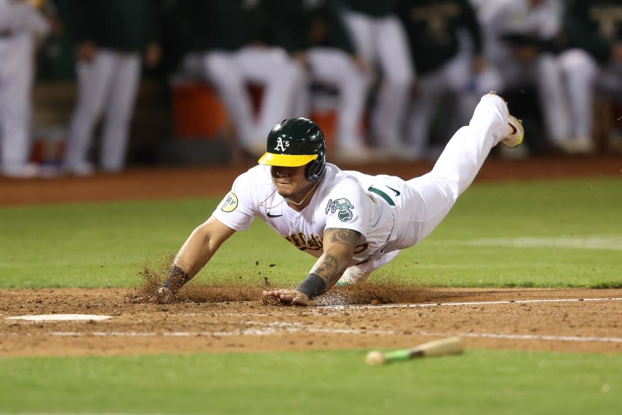 Jordan Diaz of the Oakland Athletics slides into home plate to score in the bottom of the seventh inning against the Seattle Mariners in Oakland. (Photo by Lachlan Cunningham/Getty Images)