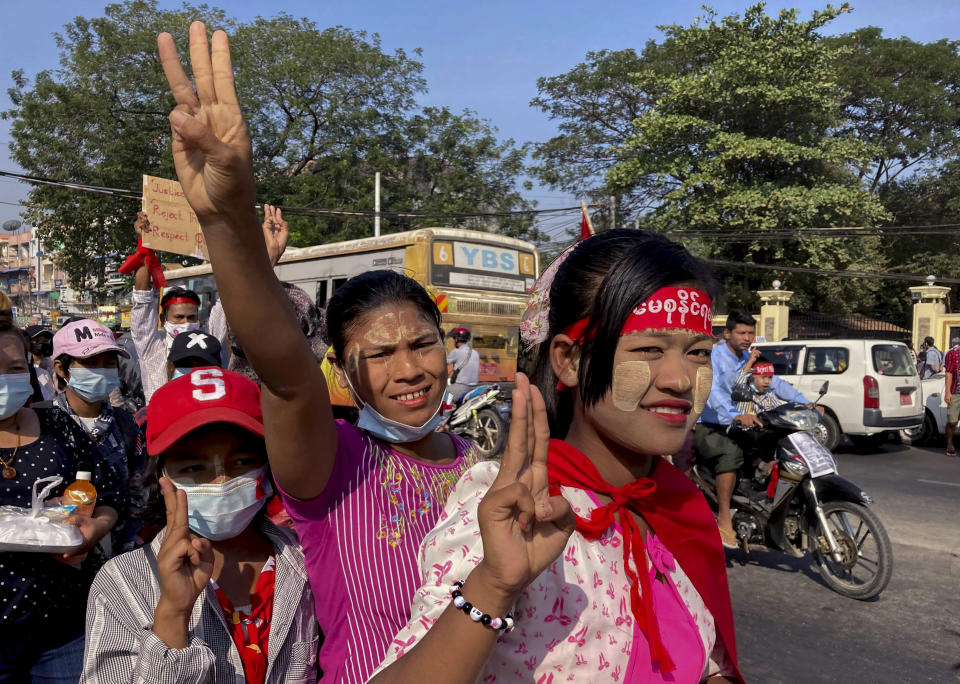 Demonstrators flash three-fingered salute against the military coup in Yangon, Myanmar Thursday, Feb. 12, 2021. Large crowds demonstrating against the military takeover in Myanmar again defied a ban on protests, even after security forces ratcheted up the use of force against them. (AP Photo)