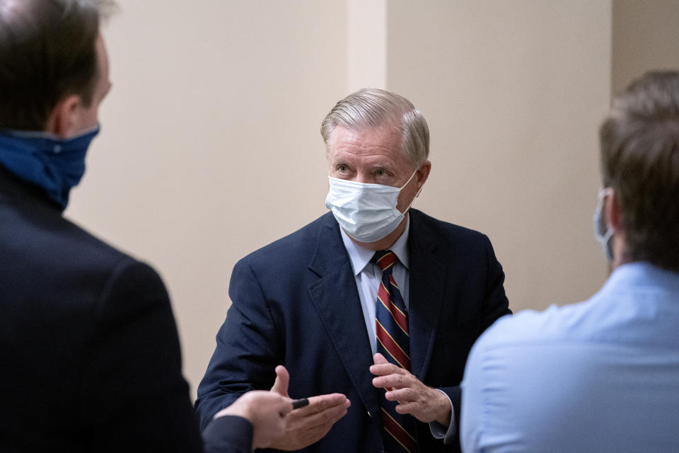 Senator Lindsey Graham, a Republican from South Carolina, center, wears a protective mask as he speaks to members of the media at the U.S. Capitol in Washington, D.C., U.S., on Monday, Nov. 9, 2020. (Stefani Reynolds/Bloomberg via Getty Images)