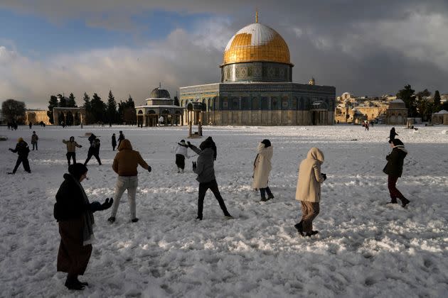 Palestinians enjoy the snow next to the Dome of the Rock Mosque in the Al Aqsa Mosque compound in Jerusalem Old city on Thursday. A rare snowfall hit parts of Israel and the West Bank, closing schools and businesses.&#xa0; (Photo: Mahmoud Illean / AP)