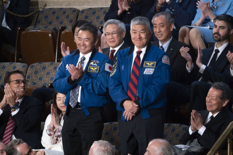 Japanese astronaut Aki Hoshide (L) and American astronaut Dan Tani smile while being recognized by Japanese Prime Minister Fumio Kishida as he addresses a joint meeting of Congress in the House of Representatives. Photo by Bonnie Cash/UPI