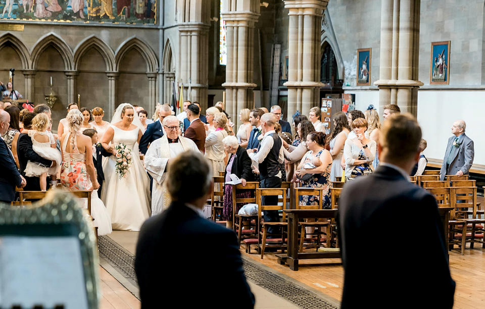 Supported by her father and her son, Emma surprised her husband by walking toward him [Photo: SWNS]