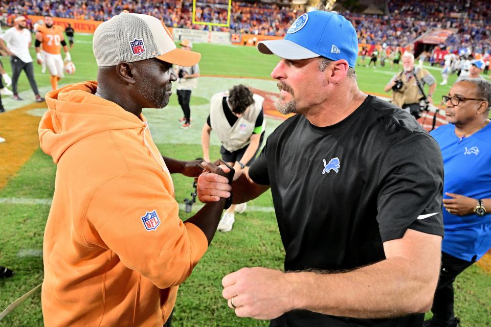 Head coach Todd Bowles of the Tampa Bay Buccaneers and head coach Dan Campbell of the Detroit Lions hug after Detroit's 20-6 win at Raymond James Stadium on October 15, 2023, in Tampa, Florida.