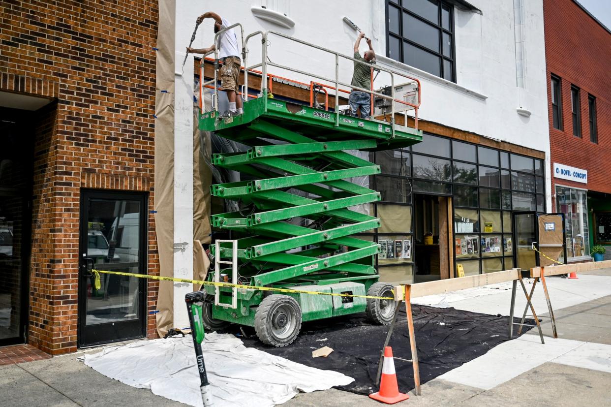 Workers paint the outside of music venue Grewal Hall at 224 on Wednesday, June 28, 2023, on Washington Square in downtown Lansing.