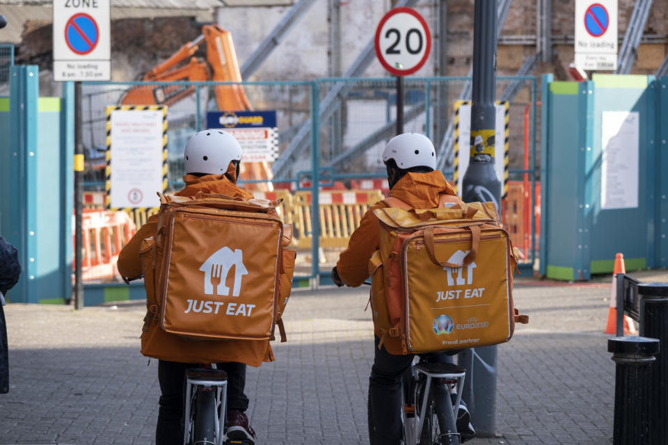 Just Eat takeaway delivery cyclists cycle along the pavement on 15th October 2021 in Birmingham, United Kingdom. Just Eat Limited is a British online food order and delivery service founded in 2001 . It acts as an intermediary between independent takeaway food outlets and customers, with thousands of cycle couriers delivering food by bicycle and other forms of transport. Gig workers are independent contractors, online platform workers, contract firm workers, on-call workers and temporary workers. Gig workers enter into formal agreements with on-demand companies to provide services to the company's clients. (photo by Mike Kemp/In Pictures via Getty Images)