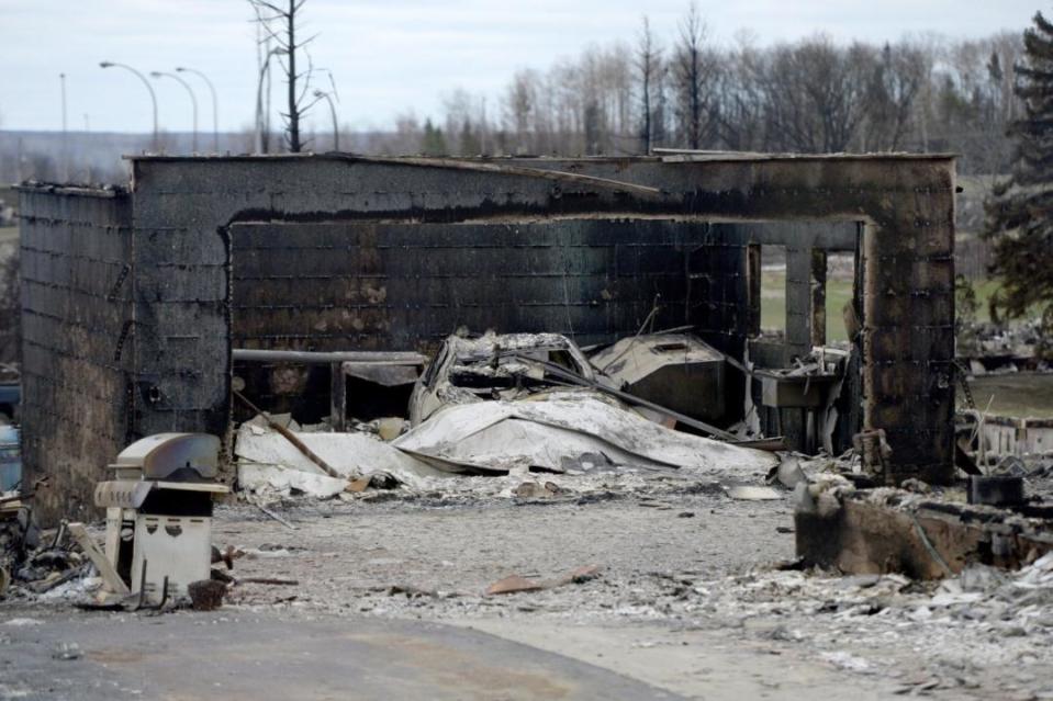 A car is shown in the garage of a burned out house in the Beacon Hill neighbourhood during a media tour of the fire-damaged city of Fort McMurray, Alta. on Monday, May 9, 2016. THE CANADIAN PRESS/Jonathan Hayward