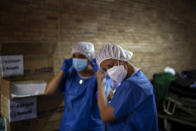 Spanish NGO Open Arms volunteers prepare to test people for COVID-19, at Vilafranca del Penedes in the Barcelona province, Spain, Tuesday, Aug. 11, 2020. Spain is facing another surge in coronavirus infections not even two months after beating back the first wave. (AP Photo/Emilio Morenatti)