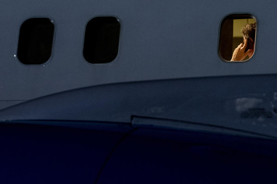 U.S. Secretary of State Antony Blinken speaks on the phone on his plane as he arrives at Lanseria International Airport in Johannesburg, South Africa, Sunday, Aug. 7, 2022. Blinken is on a ten day trip to Cambodia, Philippines, South Africa, Congo, and Rwanda. (AP Photo/Andrew Harnik, Pool)