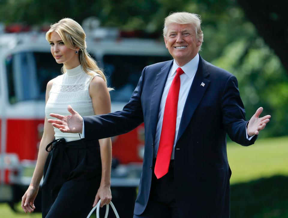 President Donald Trump smiles as he walks with his daughter Ivanka Trump across the South Lawn of the White House in Washington.
